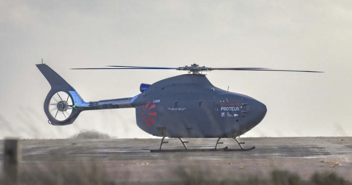 Proteus helicopter sitting on tarmac, grass in foreground 