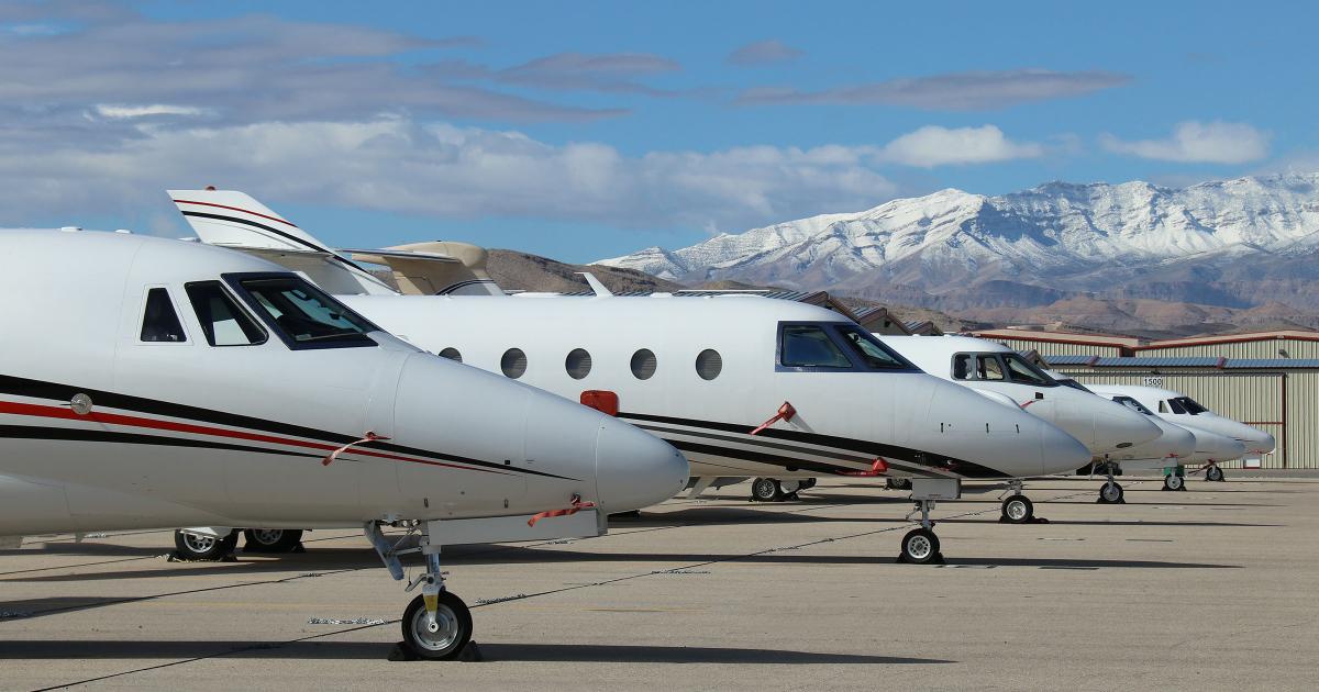 Business jets parked on ramp