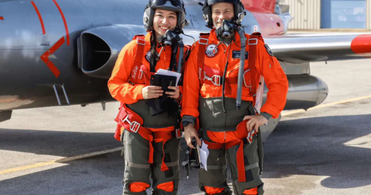 Instructor and student standing in front of aeroplane 