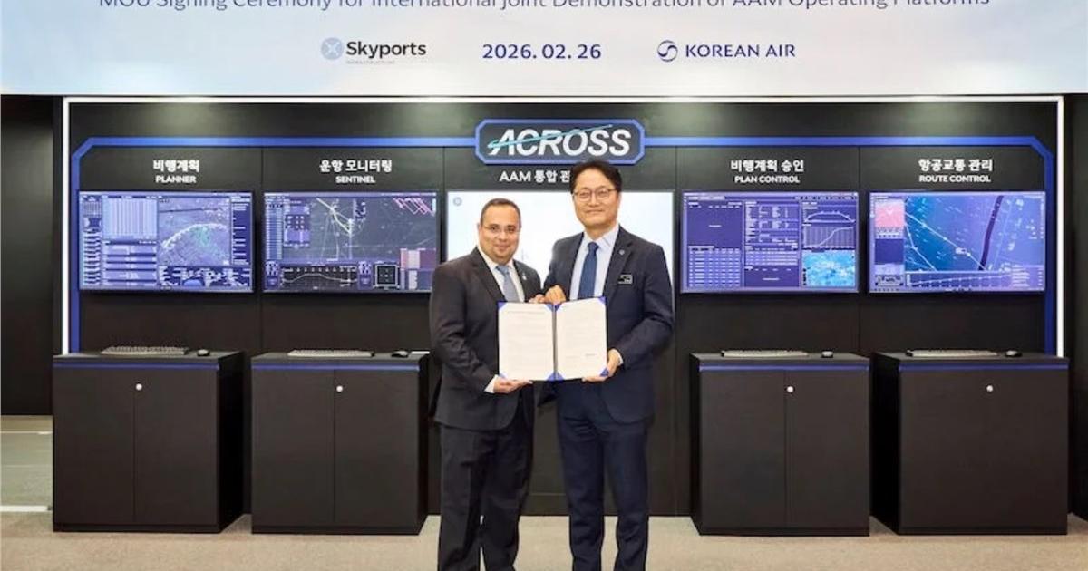 Two company representatives in front of trade stand 