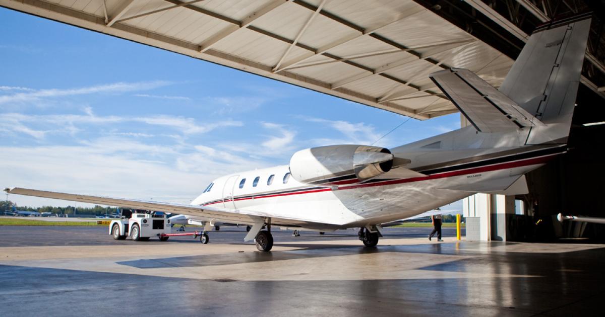 An aircraft being tugged out of a Toledo Jet hangar