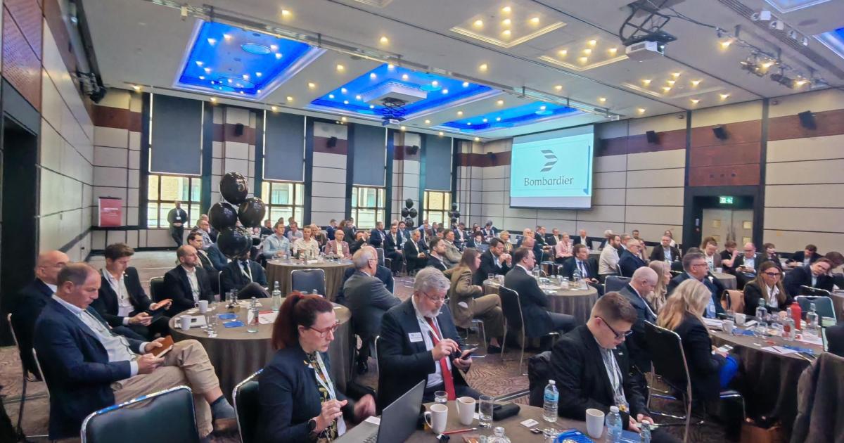 Conference room with delegates sitting at tables 