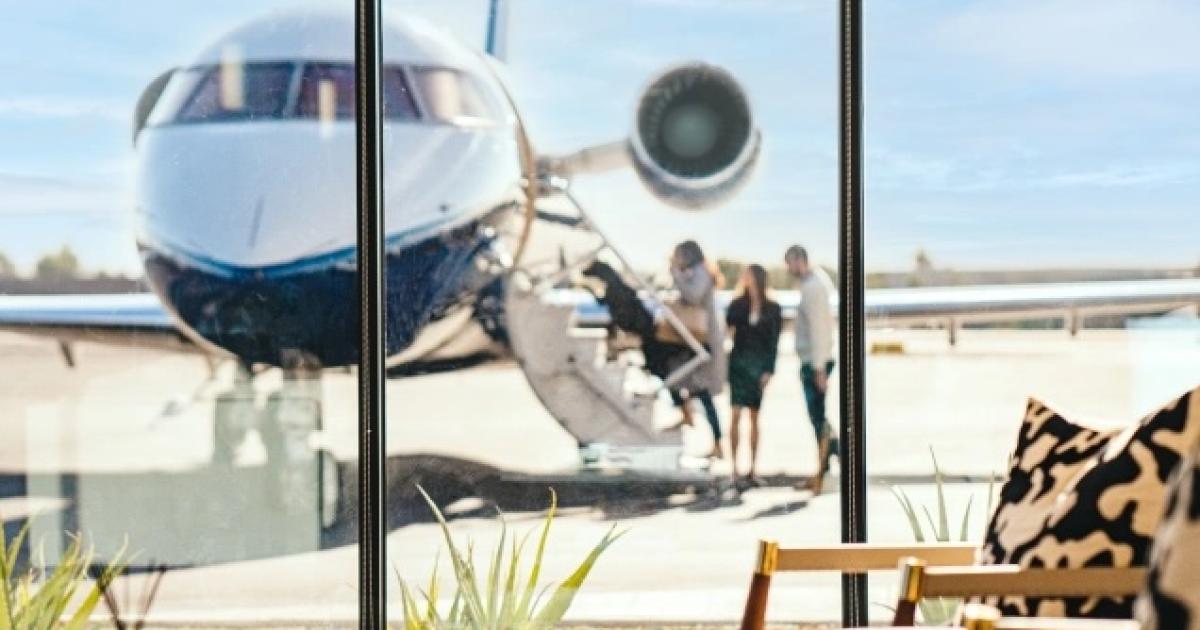 an image through an FBO window of people boarding a jet