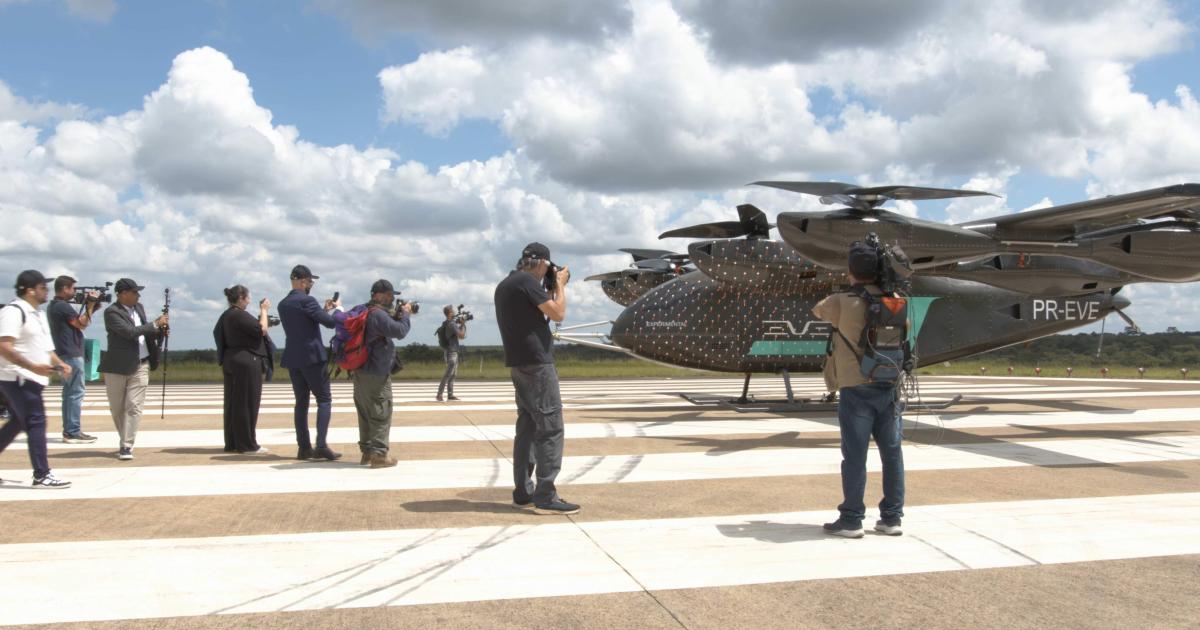 Journalists taking photos of Eve eVTOL on the tarmac 