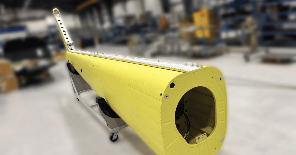 An image of the tailboom modification in a maintenance hangar