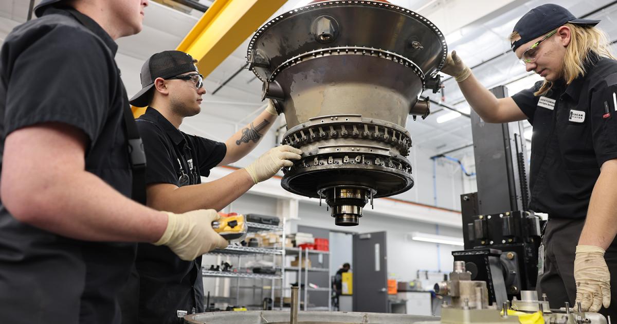 Duncan Aviation technicians working on a PW308 engine