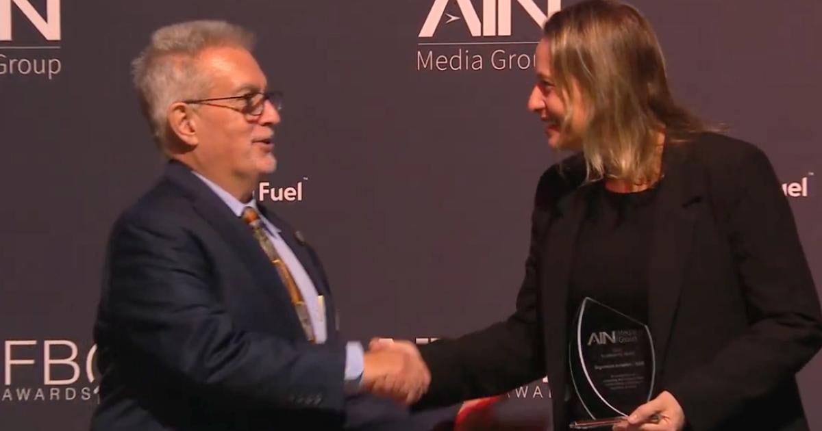 NATA president and CEO Curt Castagna congratulates Clarissa Sebastian, Signature Aviation's v-p of global sales