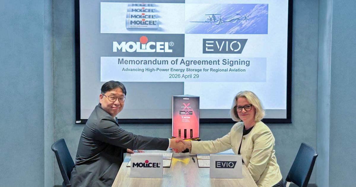 Molicel president Casey Shiue, left, and Evio vice president of operations and general manager Valerie Myers shake hands following the signing of a development agreement on April 29.