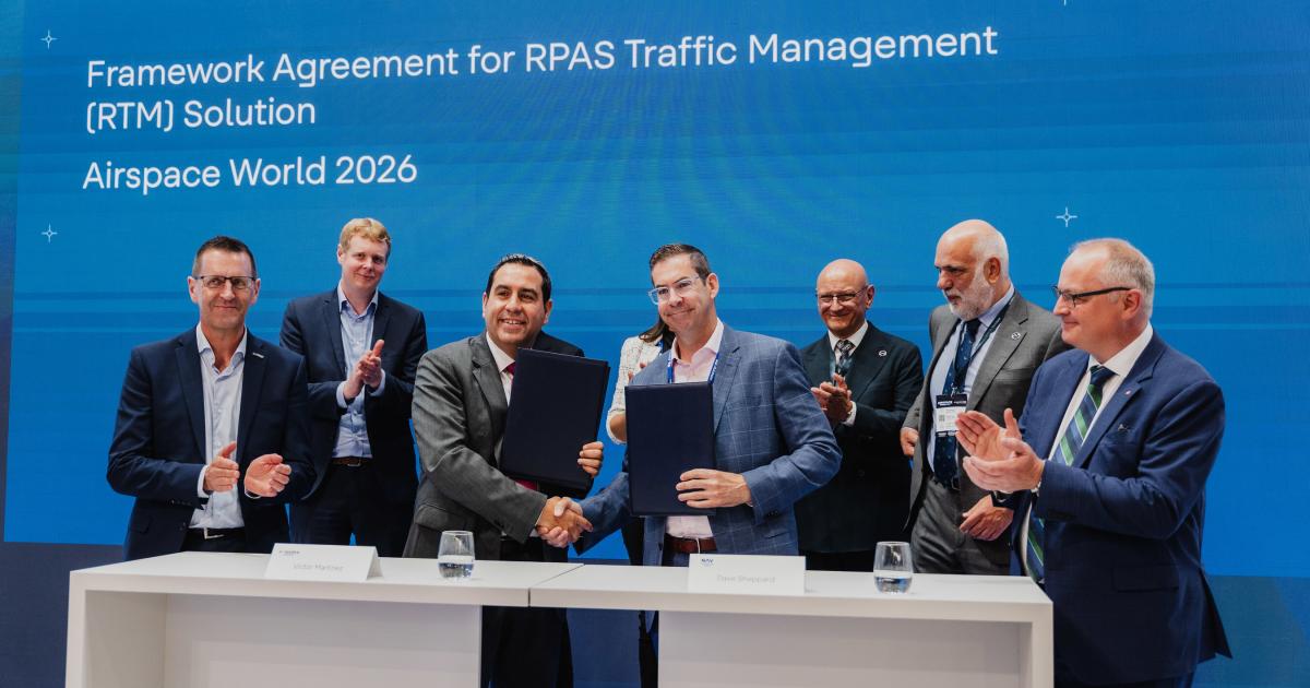 Indra Group executive vice president of ATM Victor Martínez, left, and Nav Canada vice president and chief technology and information officer David Sheppard shake hands at the rFIMS agreement signing at Airspace World 2026 in Lisbon on May 26. Also pictured are Nav Canada president and CEO Mark Cooper and RPAS Traffic Management director Alan Chapman. 