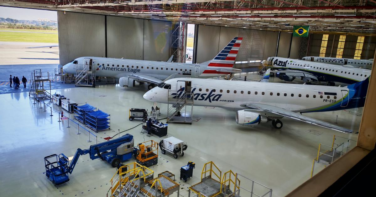 Three E-Jets in hangar with open door 
