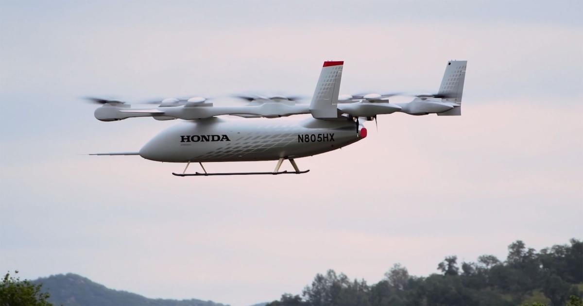 Honda's full-scale eVTOL technology demonstrator, registration N805HX, in flight over San Luis Obispo, California. The white aircraft features eight lift rotors and a pusher propeller at the tail.