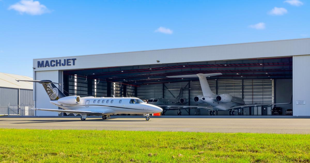 jet on ramp outside hangar