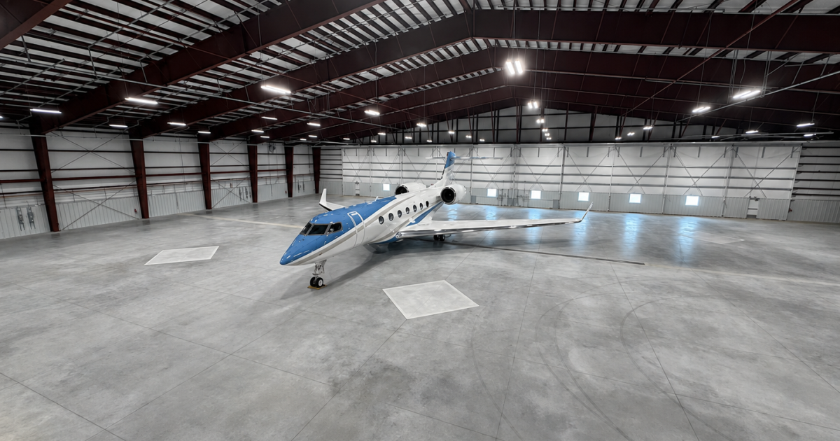 Lone business jet in large hangar
