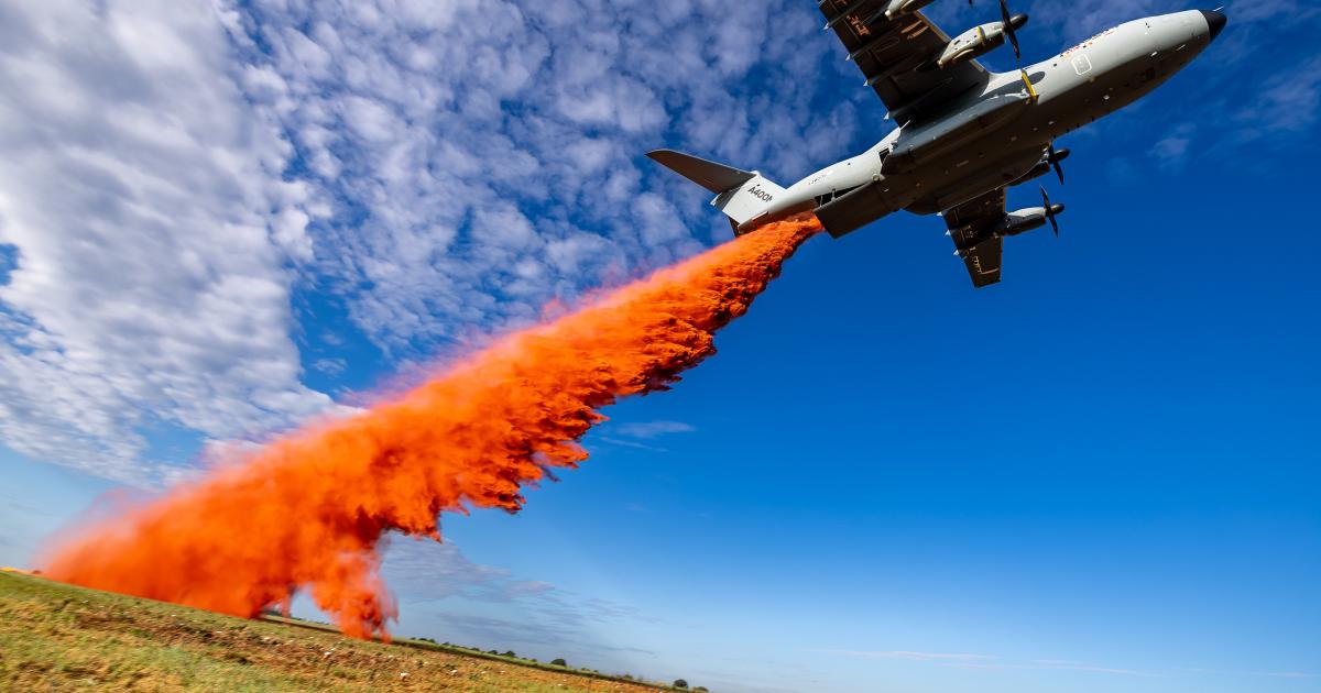 A400M flying low dropping orange retardant