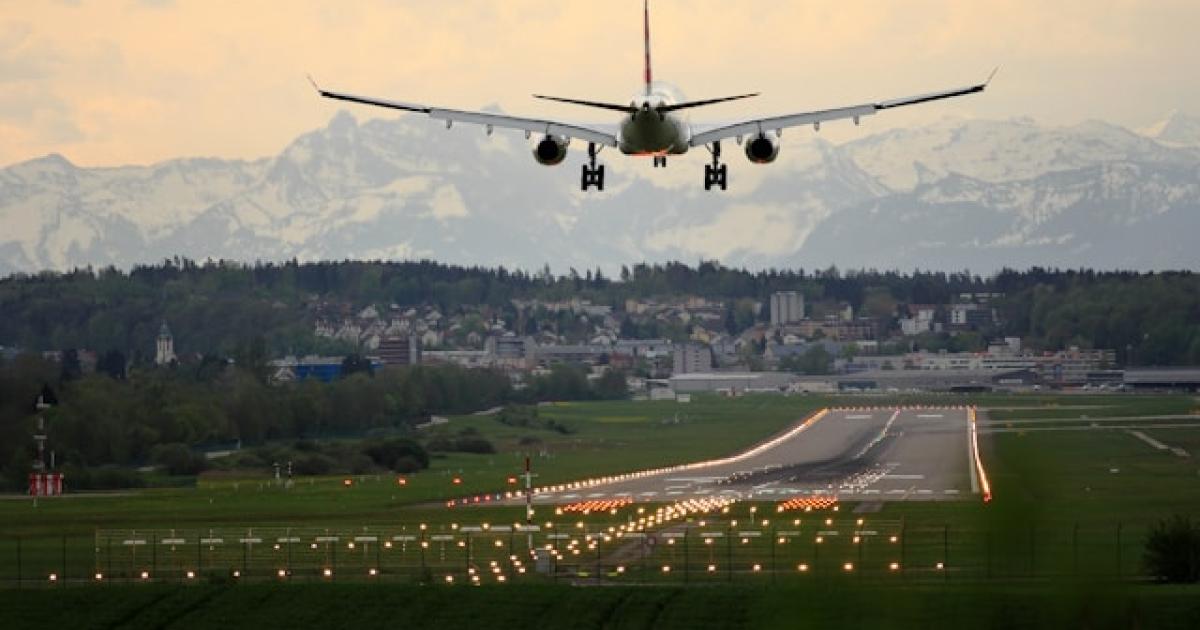 An airplane lands at Zurich Switzerland at dusk