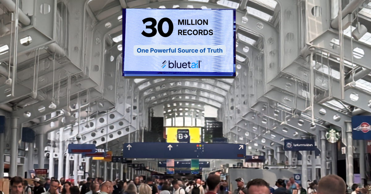 an airport terminal with a sign advertising Bluetail above the crowds