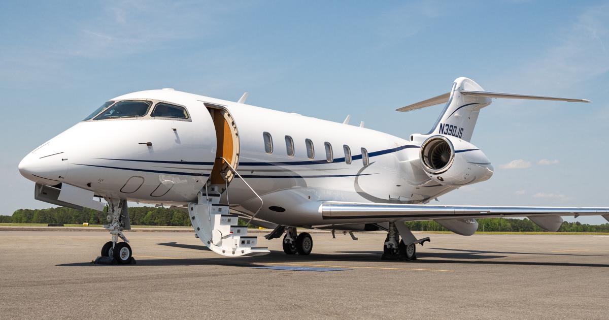 a jet parked on an airport ramp with the hatch open and stairs extended
