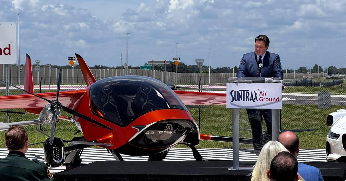 Ron DeSantis speaks beside the two-seat Air One eVTOL aircraft at SunTrax