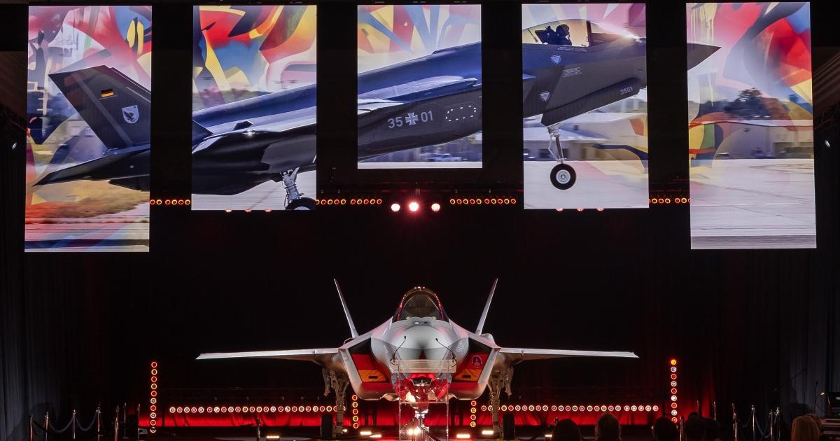 F-35 in hangar against graphics on screen 