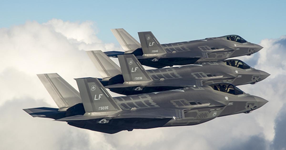 Formation of three F-35As against clouds