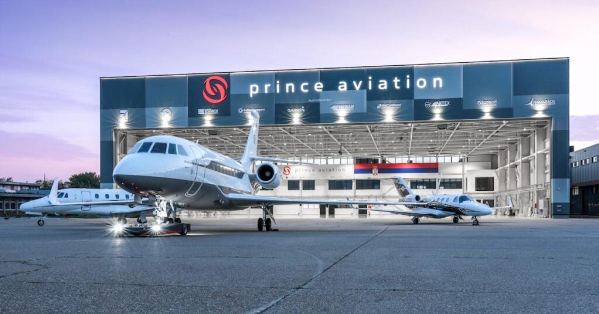 Hangar in sunset with open door, three aircraft