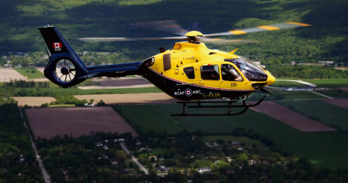 Yellow and black H135 in flight, Canadian civil registration