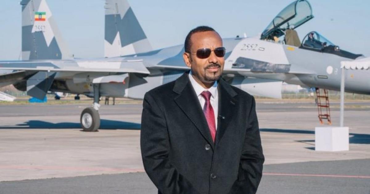 Prime minister standing in front of Su-35