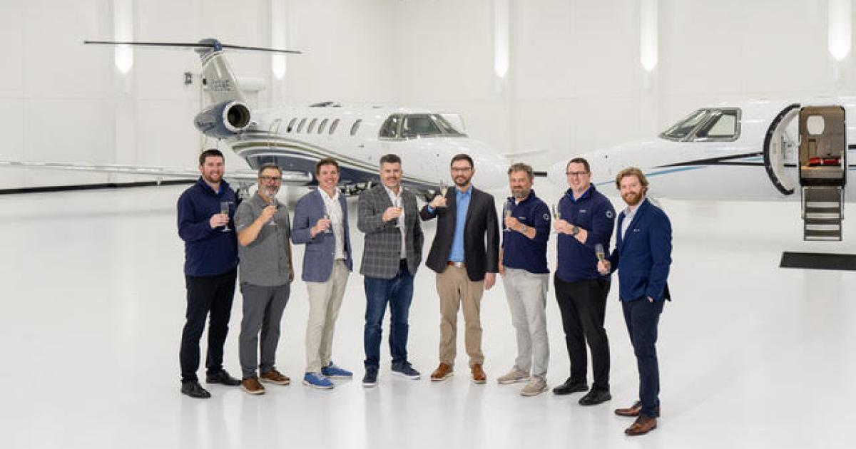 CJ4 Gen 2 in hangar with group of people standing in foreground