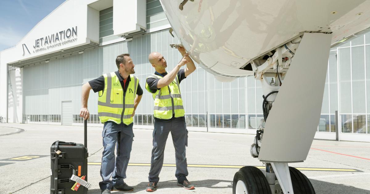 Jet Aviation techs examining aircraft outside hangar