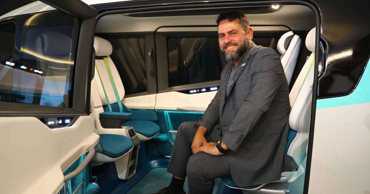 Andre Stein sits in an Eve eVTOL cabin mockup