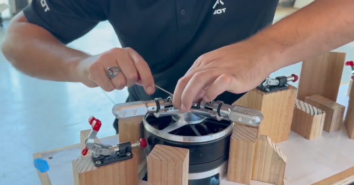 An AIBot engineer works on an eVTOL motor