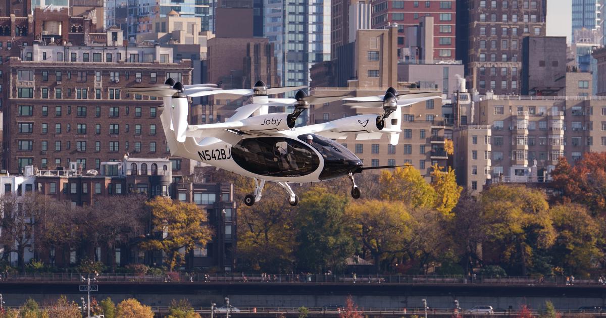 Joby's eVTOL aircraft is pictured flying in front of the NYC skyline