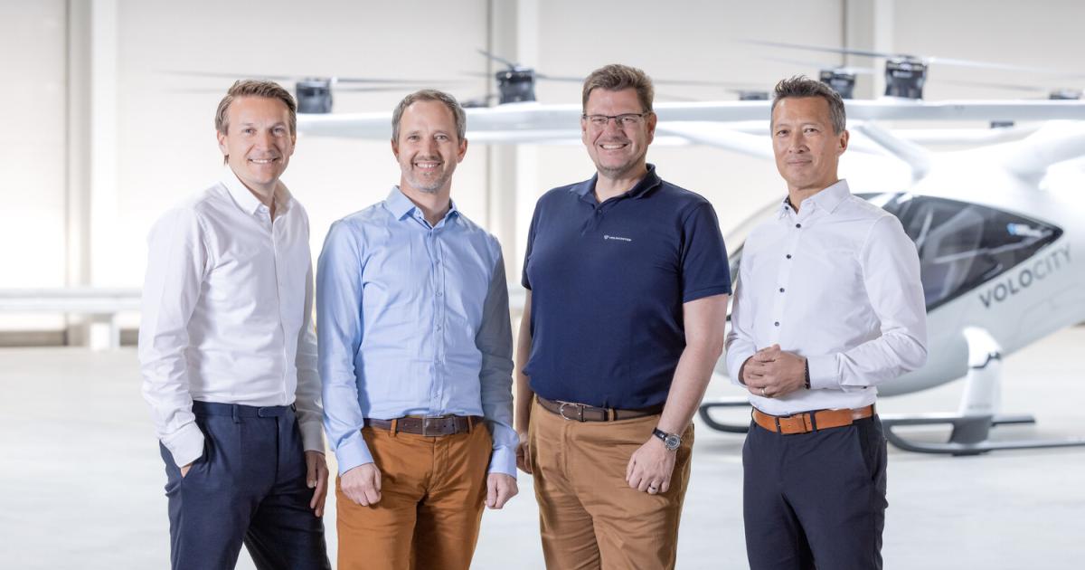 Christian Bauer CCO of Volocopter, Florian Reuter CEO of Volocopter, Stefan Klocke Chairman of the Board of Volocopter, and Dirk Hoke, future CEO of Volocopter, in front of the VoloCity