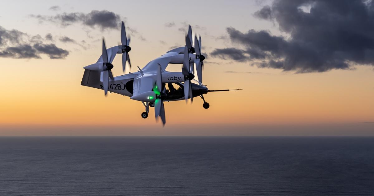Joby's eVTOL aircraft flies over the Pacific Ocean during a flight test at the company's facility in Marina, California.
