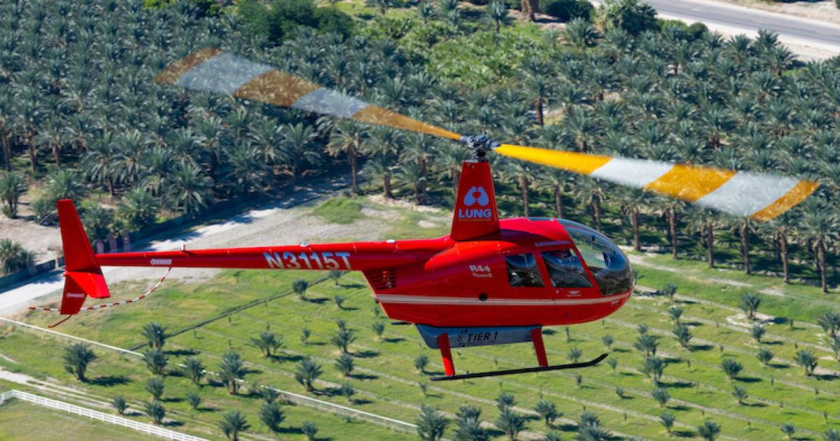 An R44 helicopter powered entirely by an electric propulsion system flies over Coachella on the way to Palm Springs International Airport.