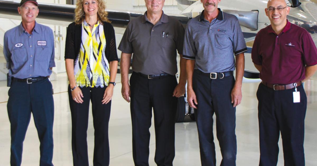 Tulip City Air Services management staff includes (from left) Mick Osborne, line department manager; Ronda Hulst, charter sales manager; Ron Ludema, director of operations; Randy Carlson, director of maintenance; and Dwight Quenga, chief pilot. Tulip City Air was honored by NBAA for logging 30,943 accident-free hours since the company was founded.