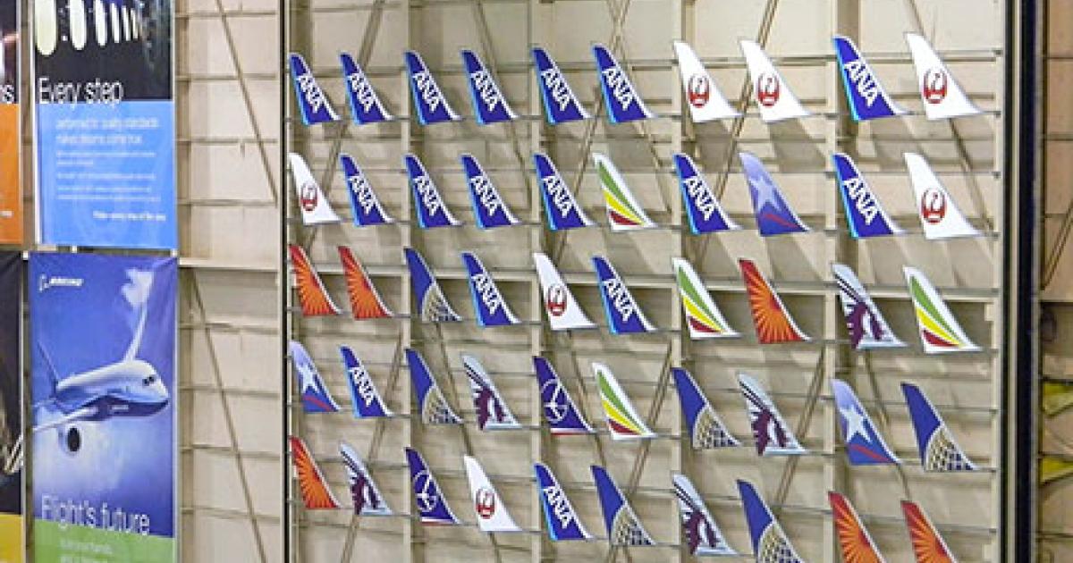 A display of delivered 787 Dreamliner tails adorns Boeing’s final assembly facility in Everett, Washington. The manufacturer said on May 29 that battery system retrofits have been completed on the delivered aircraft. (Photo: Bill Carey)