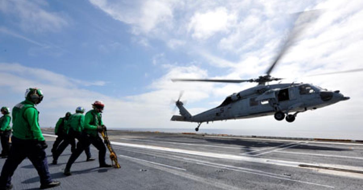 U.S. Navy MH-60R Seahawk takes off from the deck of the aircraft carrier USS Nimitz in this photo taken in October this year. (Photo: U.S. Navy)