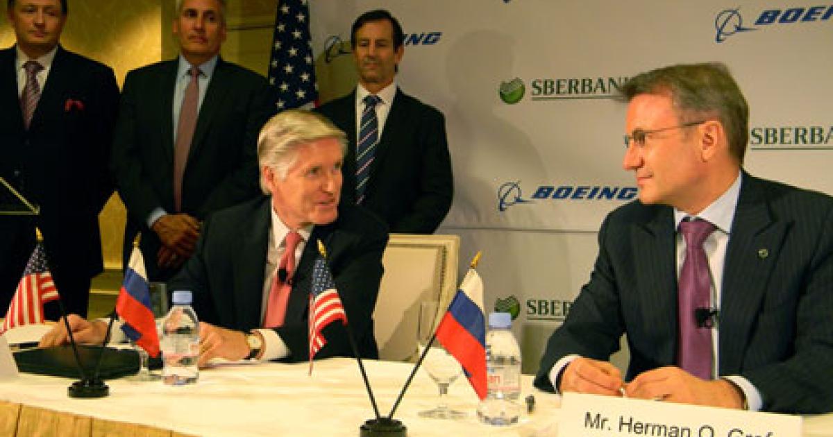 Boeing International president Shephard Hill, left, and Sberbank CEO Herman Gref sign an order for 12 Boeing 737-800s in Washington, D.C. (Photo: Bill Carey) 