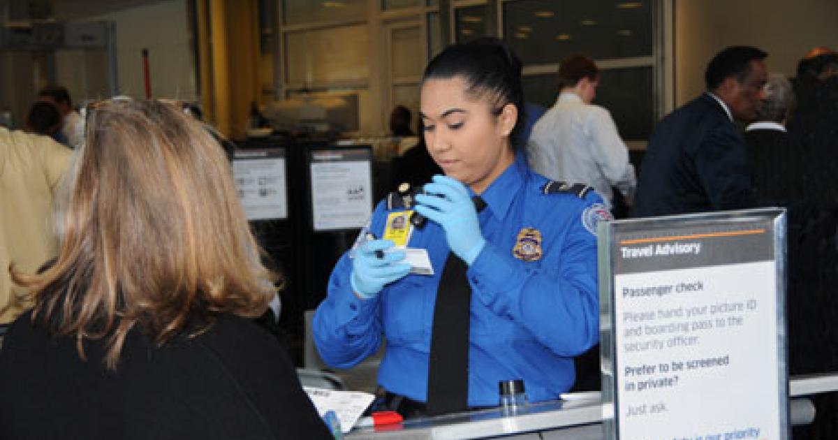 A TSA agent checks the authenticity of a passenger’s identification. (Photo: Department of Homeland Security)