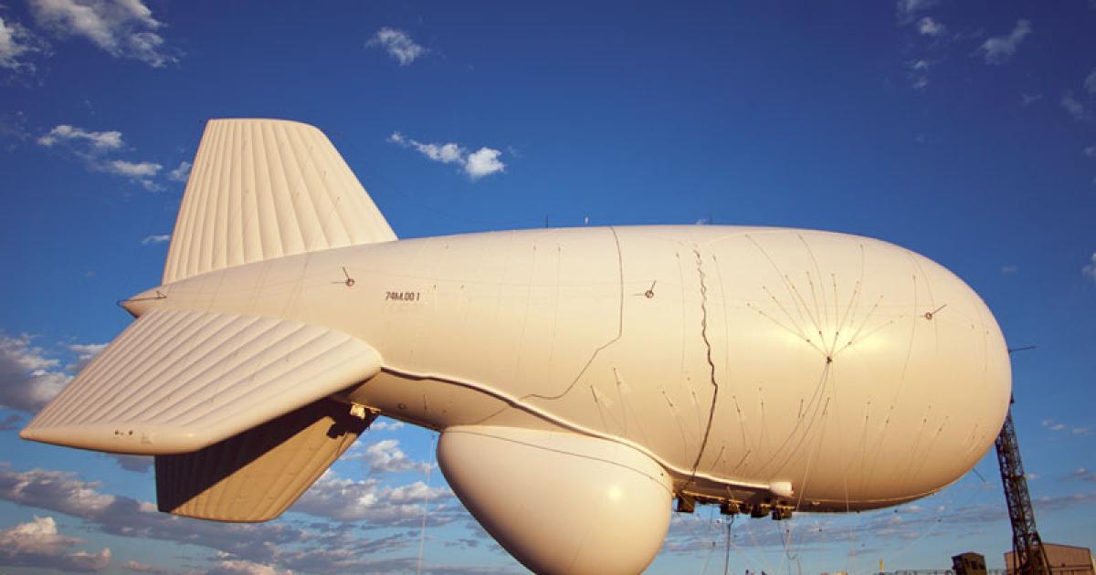 This 590,000-cu-ft aerostat is the largest yet flown for a military surveillance mission. It was fabricated by TCOM for the Raytheon JLENS development program. Like similar radar-carrying aerostats, the sensor is housed in a separate, pressurized compartment below the main envelope. (credit: Raytheon). 