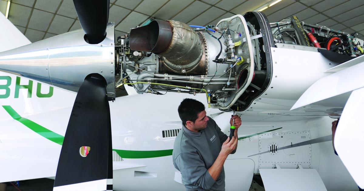 A Ruag engine mechanic works on a Piaggio Avanti turboprop.