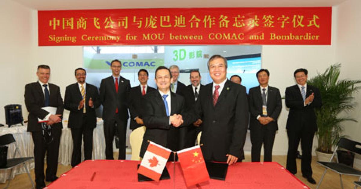 Bombardier Commercial Aircraft president Mike Arcamone (left, foreground) and Comac vice president Wu Guanghui celebrate the signing of a new MOU between their companies marking the start of the next phase of their collaboration. (Photo: Bombardier) 