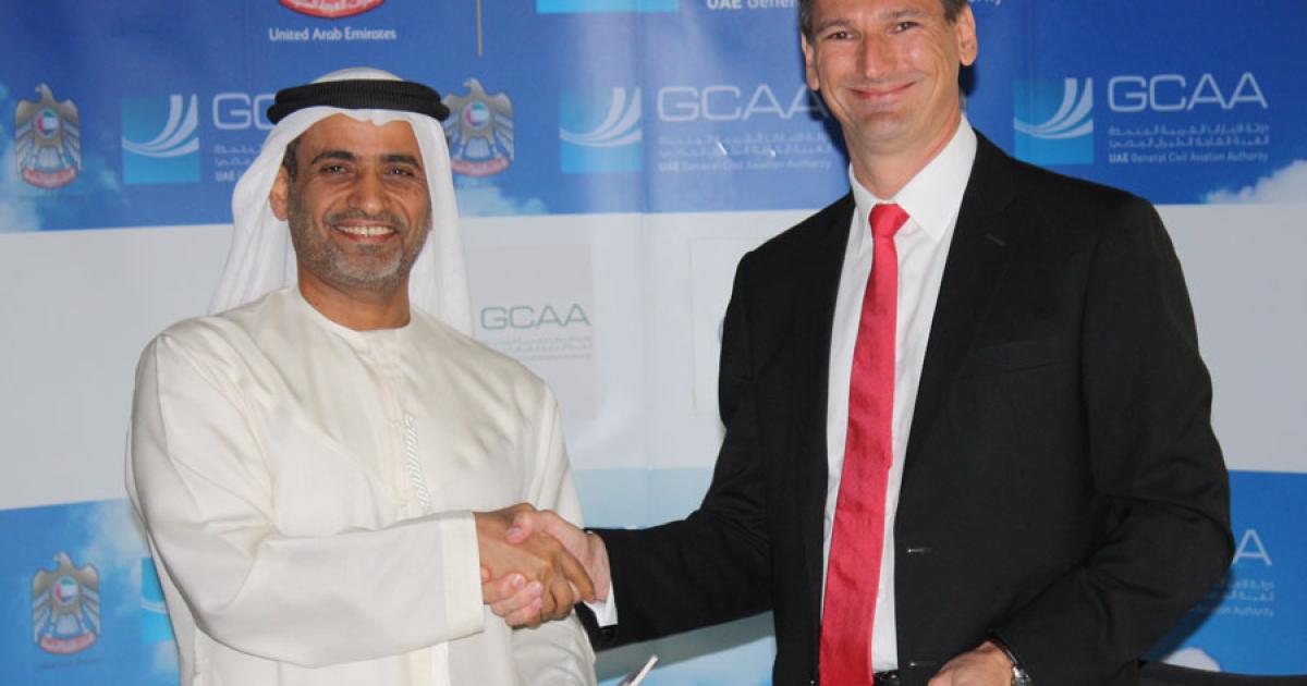 H.E. Saif Mohammed Al Suwaidi, UAE General Civil Aviation Authority director general (left), and François Cognard, Airbus Middle East vice president of sales, celebrate the signing of an agreement to study UAE airspace restructuring. (Photo: Airbus ProSky)