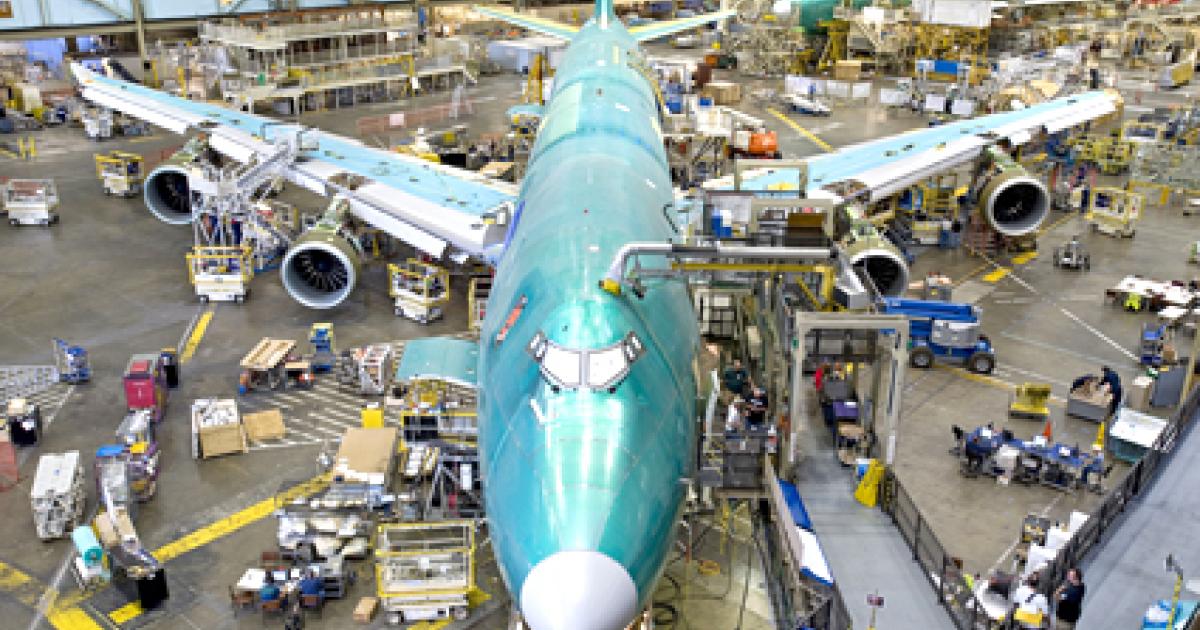 Boeing stopped moving airplanes forward on its Everett, Wash., 747-8 production line to complete work that has mounted as it gears up for a production increase starting next April. 