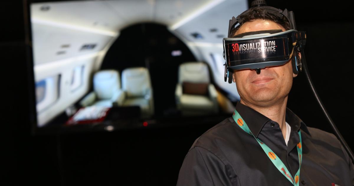 3DVisualization Service president J.P. Mangano shows off the company’s virtual reality headset, which customers can use to walk through the interior of their aircraft before it is completed.