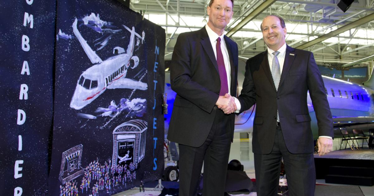 (L-r): NetJets vice president of fleet planning and acquisitions Donald Strench and Bombardier Business Aircraft vice president of worldwide strategic accounts Ray Jones celebrate the rollout of the first Global-series jet for the fractional provider. The aircraft will now be outfitted and painted at Bombardier’s Global completion center in Dorval, Quebec, before it is delivered to NetJets later this year. 