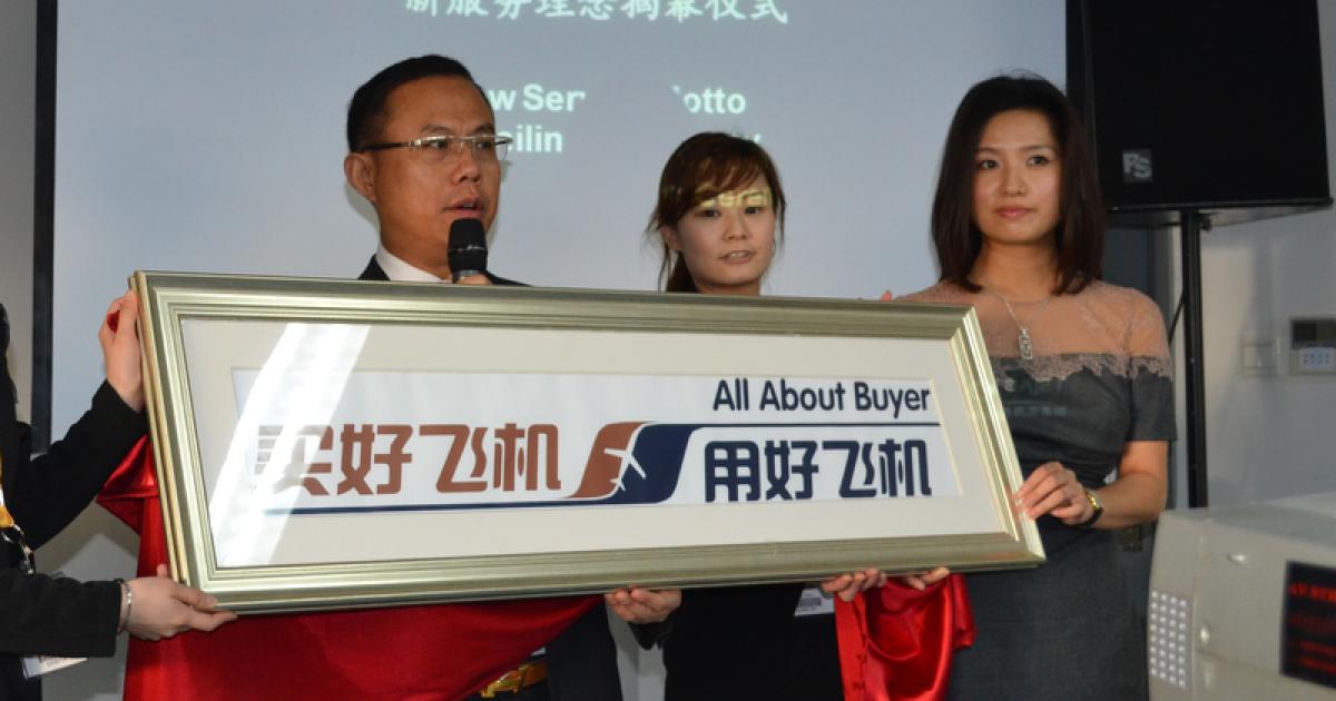 Jason Liao, chairman and CEO of China Business Aviation Group, shows off his company's new slogan. CBAB is selling three business jets to a stem-cell research firm.