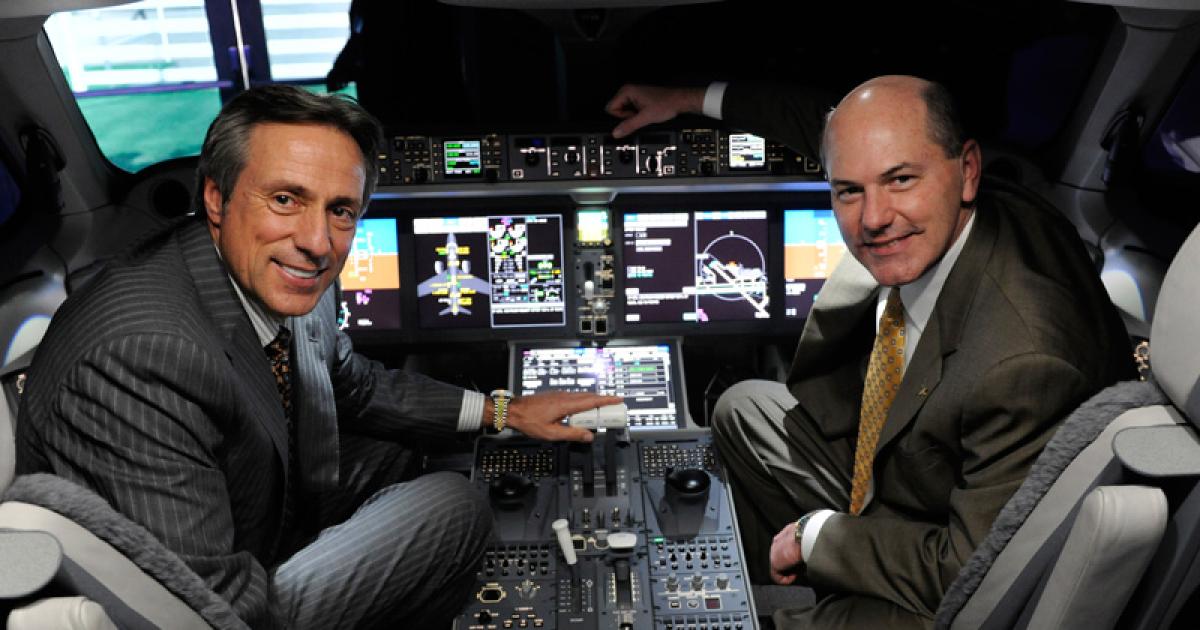 Guy Hachey, Bombardier president and COO (left) and Chet Fuller, senior v-p of sales, in CSeries cockpit demonstrator. (Photo: Mark Wagner)