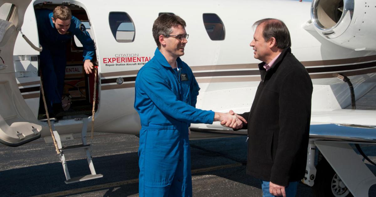 Cessna president and CEO Scott Ernest congratulates engineering test pilot Pete Fisher after the successful first flight of the Citation M2 prototype on Friday.
